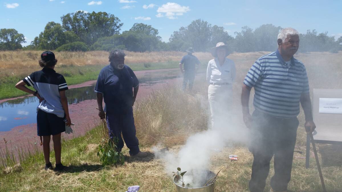 Elder Harry Nannup conducting a Smoking Ceremony to bless works on the Serpentine River. Photo: Supplied.