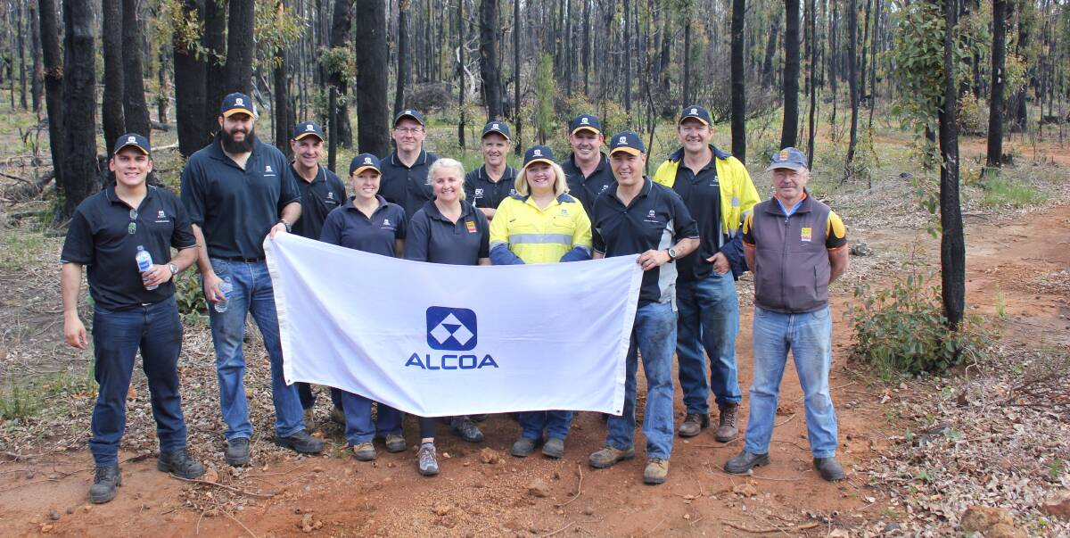 On track: Alcoa employees volunteer on the Munda Biddi Trail to restore a section of the trail after the January Yarloop-Waroona bush fires. Photo: Supplied.
