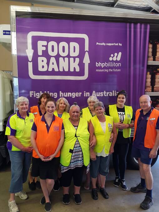 Fighting hunger: Megan Reynolds with staff members Peter Retallack and Sophia Hornsby (all in orange vests) and volunteers are Sandra, Polly, Carol, Tara, Vicki and Courtney. Photo: Supplied.