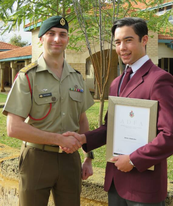 The Australian Defence Force's Captain Rob Mueller presents Mandurah Catholic College Year 12 Zavier Radecker with an award for his leadership potential. Photo: Supplied.