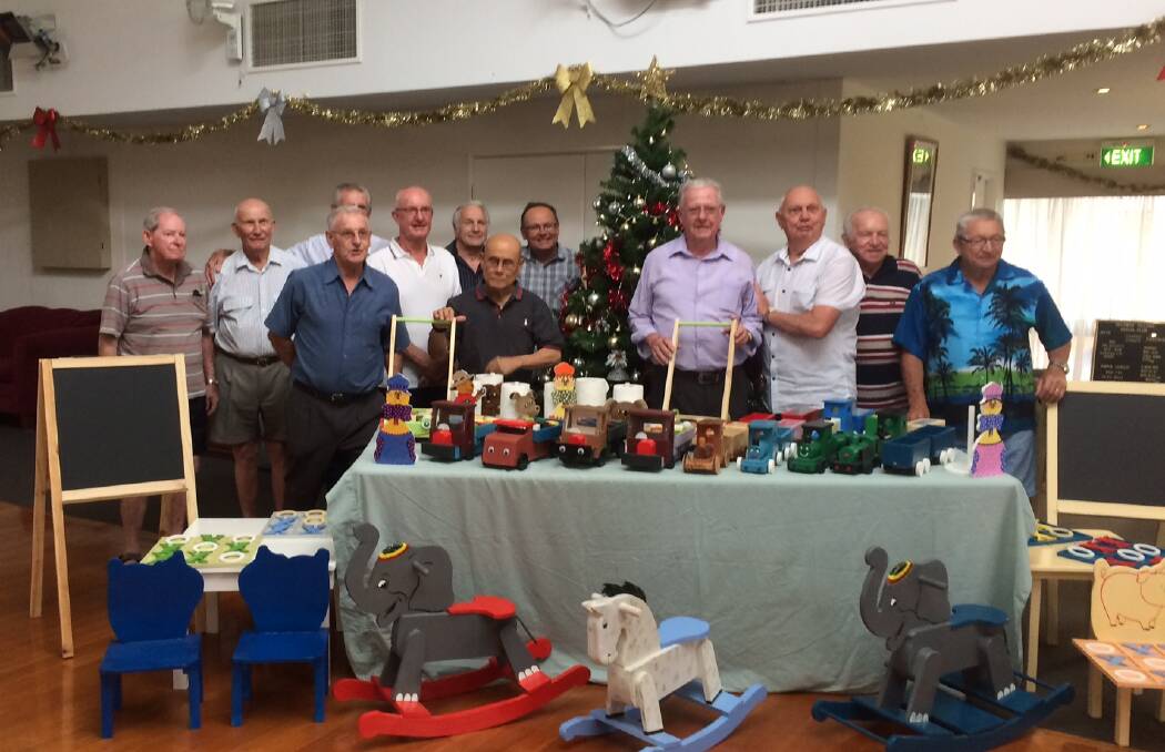 Giving spirit: Mandurah MP David Templeman with members of the Belswan Men’s Cave and the toys they have made for local children. Photo: Supplied.