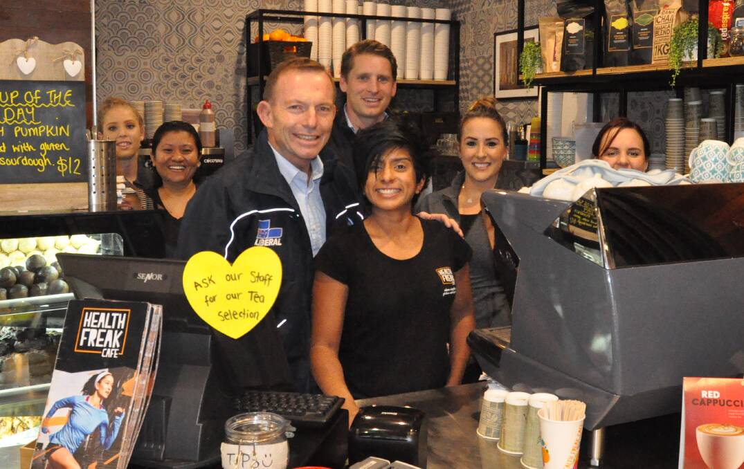 Campaign trail: Former Prime Minister Tony Abbott with Canning MP Andrew Hastie and staff from Health Freak Cafe at Halls Head Central. Photo: Nathan Hondros.