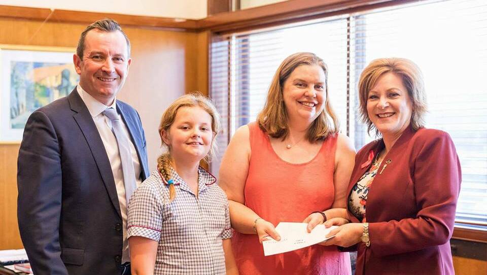Gift: Premier Mark McGowan and Murray-Wellington MP Robyn Clark present cancer survivor Fiona Hancock and her daughter Erica with tickets to Paris. Photo: Supplied.