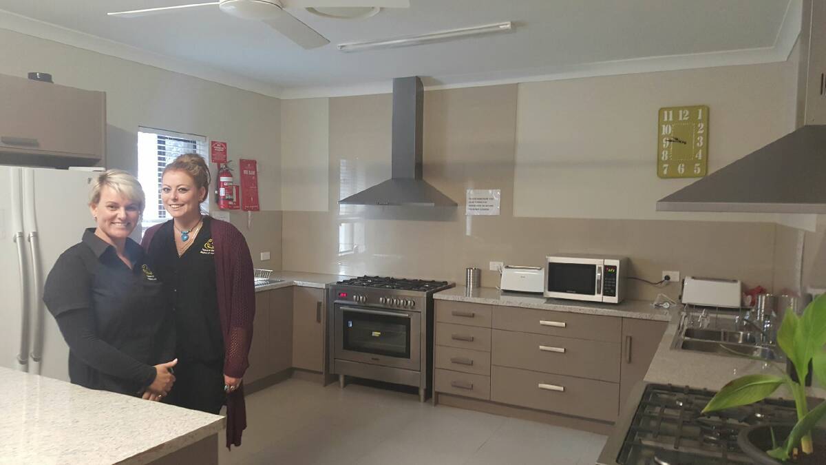 Fitout: Pat Thomas House service manager Kim Stevens and Womenzlink Advocate Kirra Grenfell in the new kitchen. Photo: Supplied.