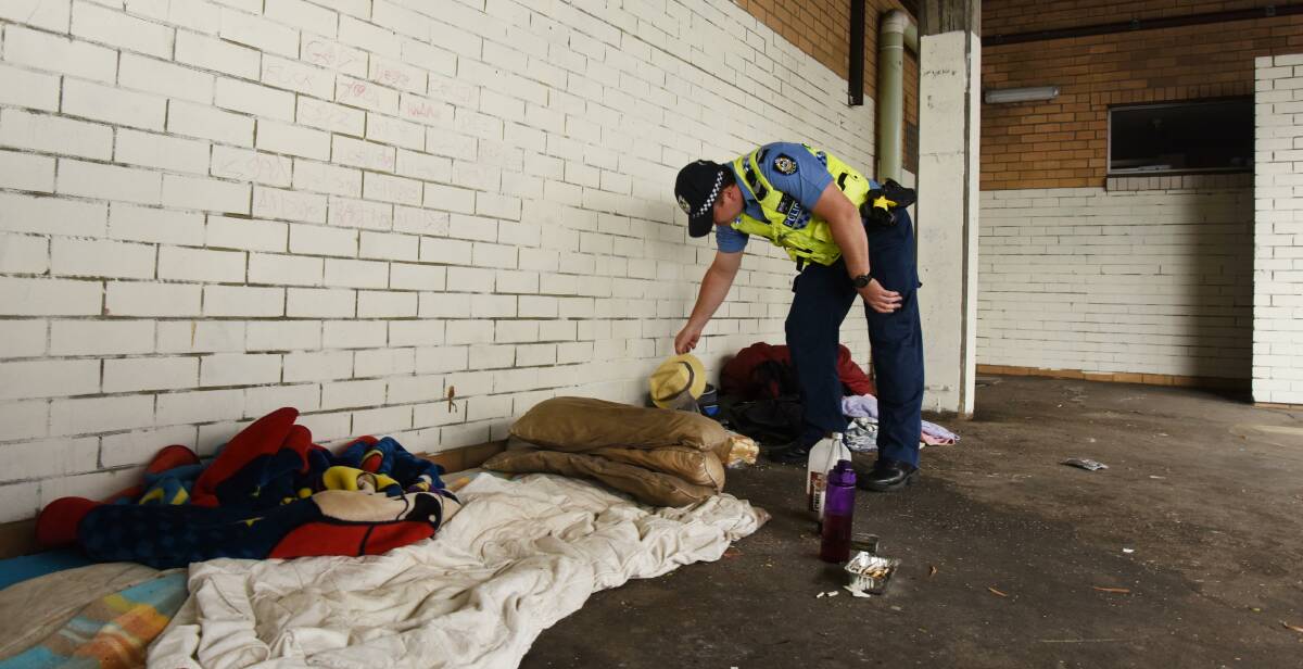 Customary check: Senior constable Russel Lindquist checks a common spot among homeless people to spend the night at. Photo: Marta Pascual Juanola.