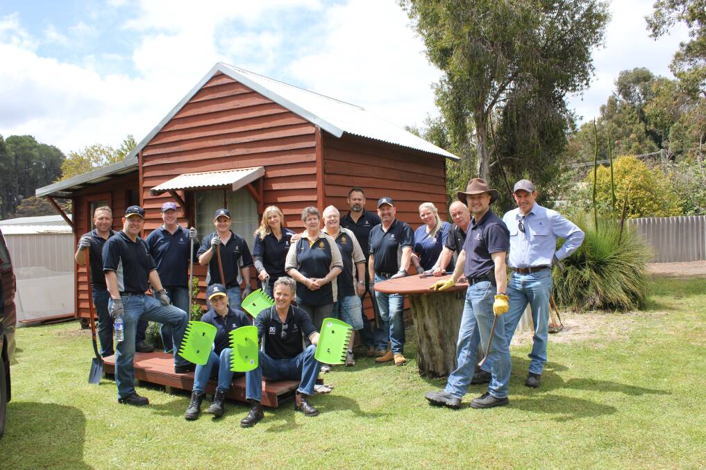 Group effort: Huntly Mine volunteers at the R&SL shed, where they moved some bricks and timber to make way for white ant treatment. Photo: Supplied.