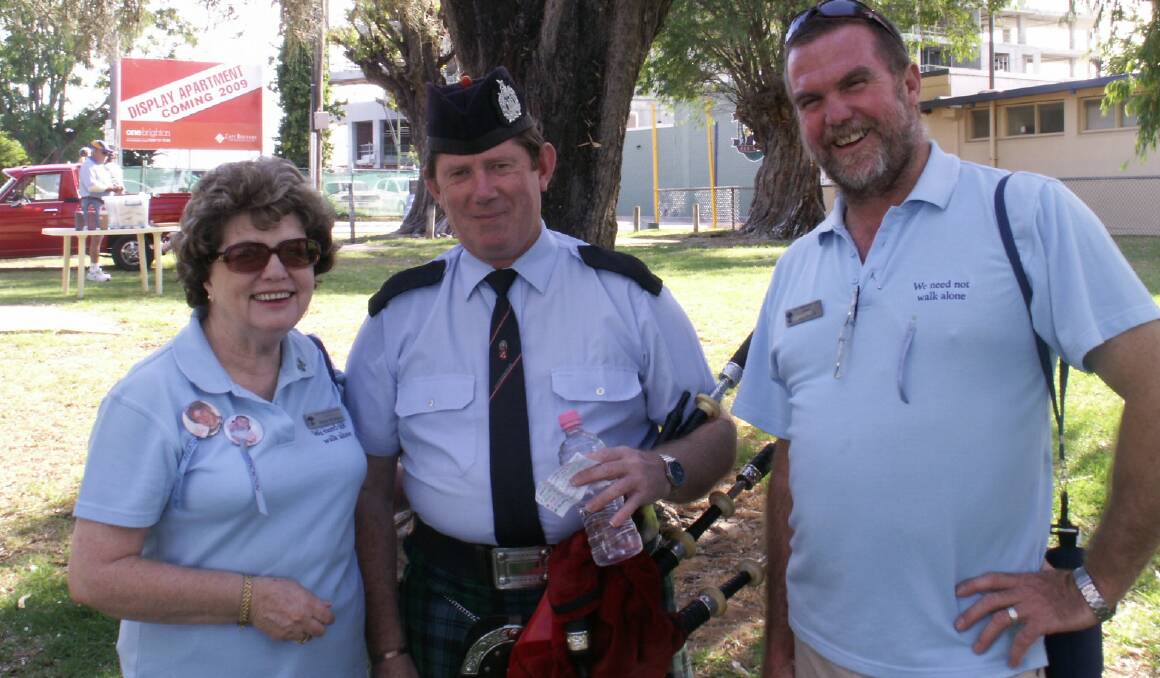 Tribute: Margaret McAllister shows me, piper Viv Riley and TCF president Gary Withers at the 2017 Walk to Remember. Photo: Supplied. 