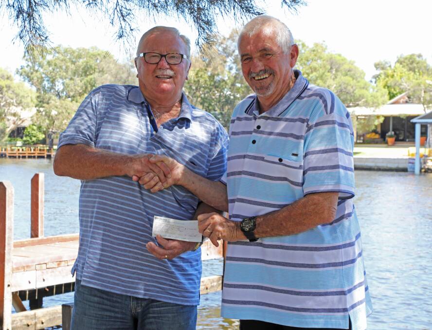 Colin Elton, past Chairman of the Friends of the Rivers Peel is pictured handing a $1700 cheque to Chairperson, of Mandurah Environment and Heritage Group, Barry Small.
