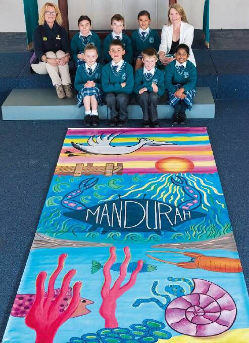 Year 3 students from Living Waters Lutheran College with their vibrant banner, alongside teacher Carla Stubenrauch and Councilor Jane Field. Photo: Supplied.