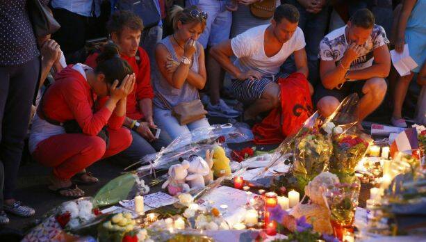 No-go zone: People pay their respects to the victims at a makeshift memorial in Nice, southern France on July 14.  Photo: AP