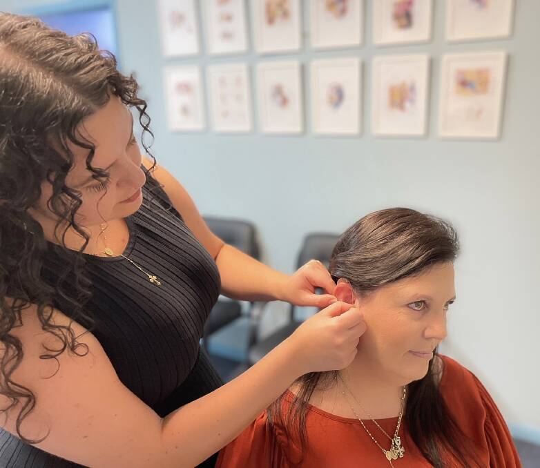 Josephine Khairy having her Genesis AI hearing aids being fitted by an Audiologist. The device has changed her life and given her more confidence. Picture supplied