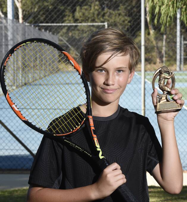 ALL SMILES: Upcoming tennis star Byron Nottle shows off his trophy after taking out the under 12 boys' singles title at the South Mandurah Tennis Club junior championships on Tuesday. Photo: Richard Polden.