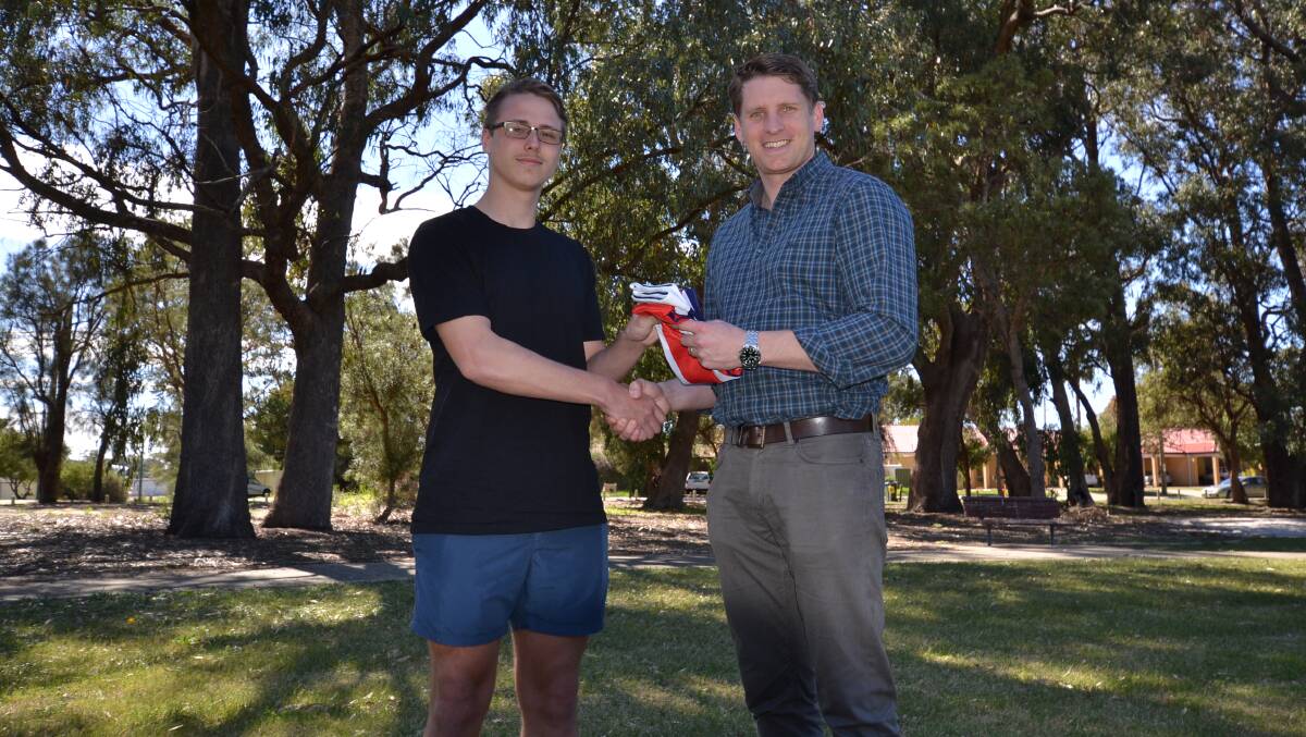 Canning MP Andrew Hastie presents local soccer star Raymond Ellery with an Australian flag to take with him to the World Championships in Argentina. Photo: Justin Rake.  