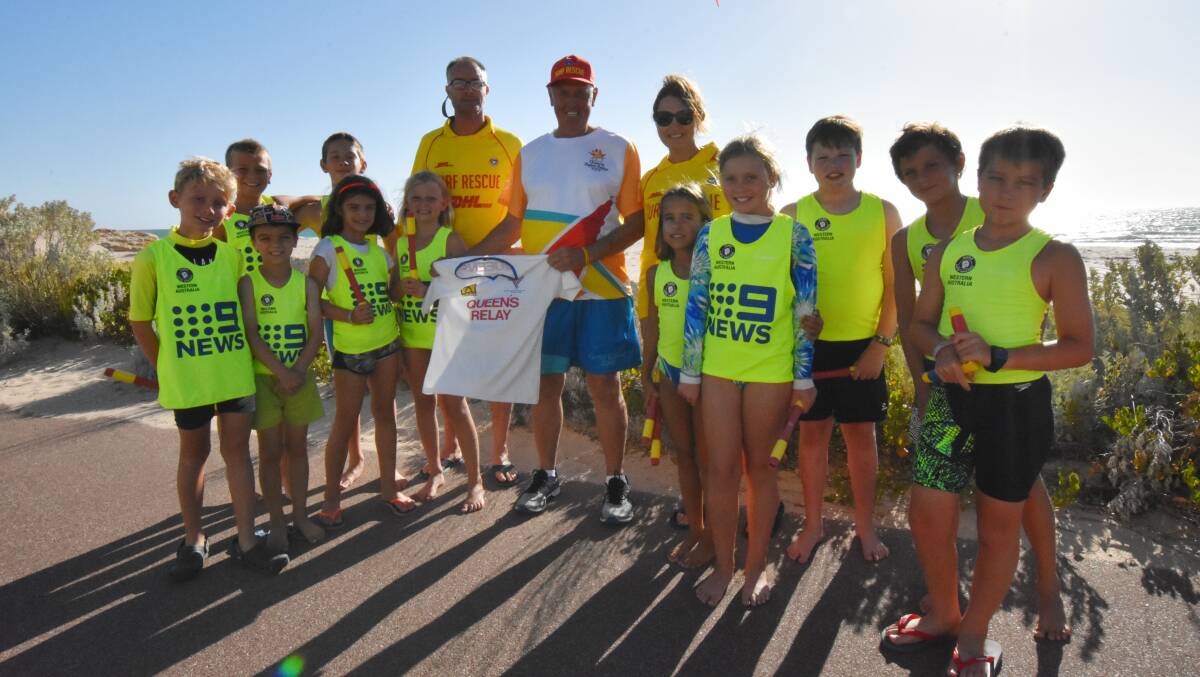 Murray Horbury shows both his 1982 and 2018 Queen's Baton Relay shirts off to Richard and Karen Cleveland and the youngsters from Port Bouvard Surf Life Saving Club. Photo: Justin Rake.     