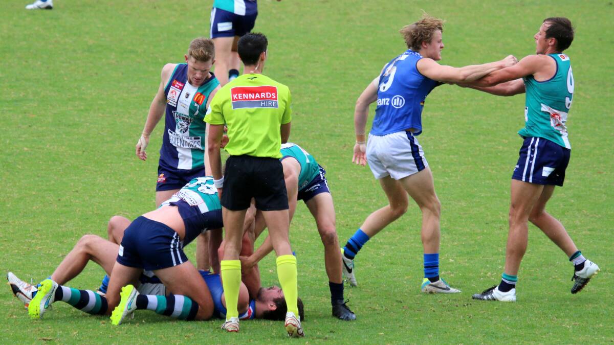 The umpire tries to break up a skirmish in the match. Photo: Coni Forrestall.