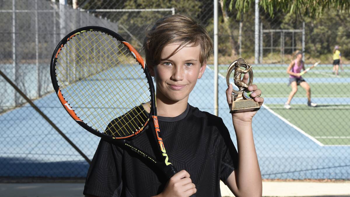 Upcoming tennis star Byron Nottle shows off his trophy after taking out the under 12 boys' singles title at the South Mandurah Tennis Club junior championships. Photo: Richard Polden.