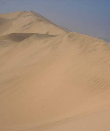 I had the chance to visit Namibia from South Africa. A four wheel drive, up, over and down immense sand dunes was both scary and exciting.

This picture of two people in the dunes helps one realise both how big the dunes are, as well as their proximity of the Atlantic Ocean. Photo: Peter Conroy
