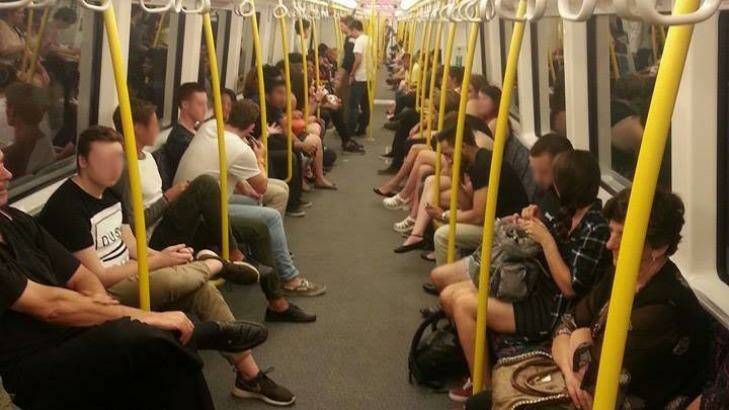 1 am on Saturday morning and commuters fill the carriage of a late night train planned to be cancelled by the PTA 