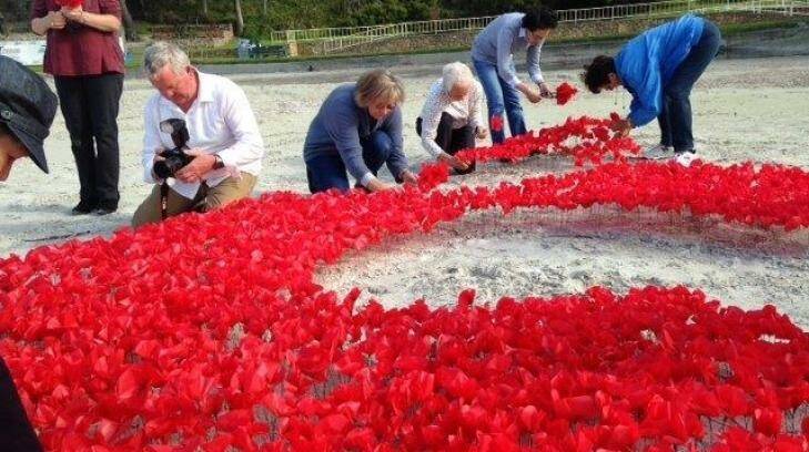 Volunteers prepare the poppies for Albany's Anzac memorial.