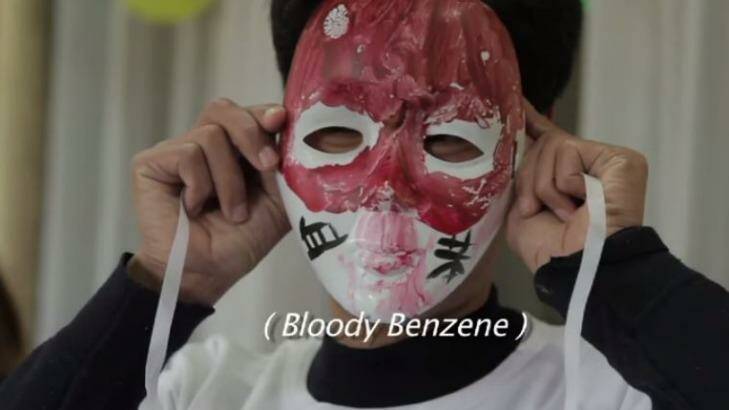 In the film, 'Who pays the price?' a protester objects to the use of benzene in smartphone production. Photo: Screenshot