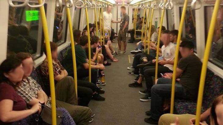 Commuters fill the carriage of a late night train planned to be cancelled by the PTA 