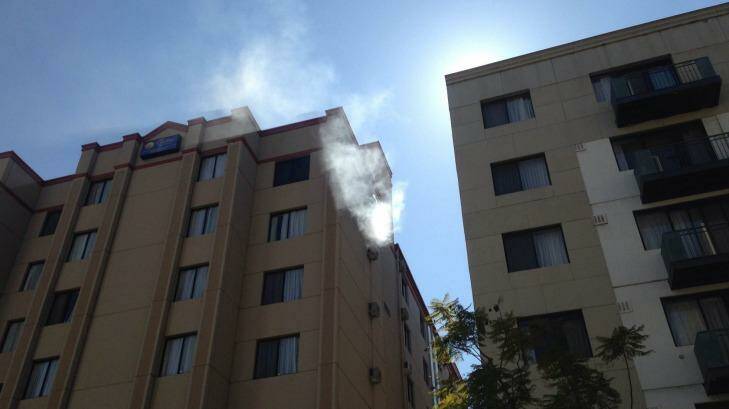 Smoke can be seen coming from the air-conditioning unit.