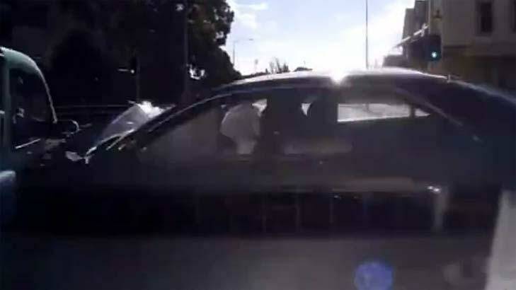 The footage shows airbags going off as the dark-coloured car smashes into the London Cab. Photo: Dash Cam Owners Australia Facebook