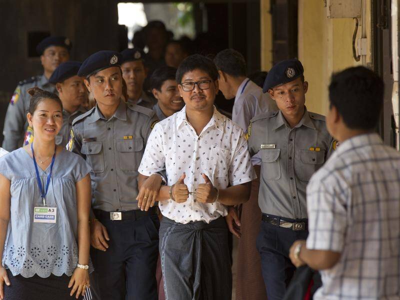 Journalist Wa Lone, c, and Kyaw Soe Oo (not pictured), face charges under the Officials Secrets Act.
