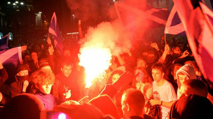 "Yes" supporters burn flares as they react to the polls closing in George Square as Scotland awaits the results of the Scottish Independence referendum vote. Photo: Getty