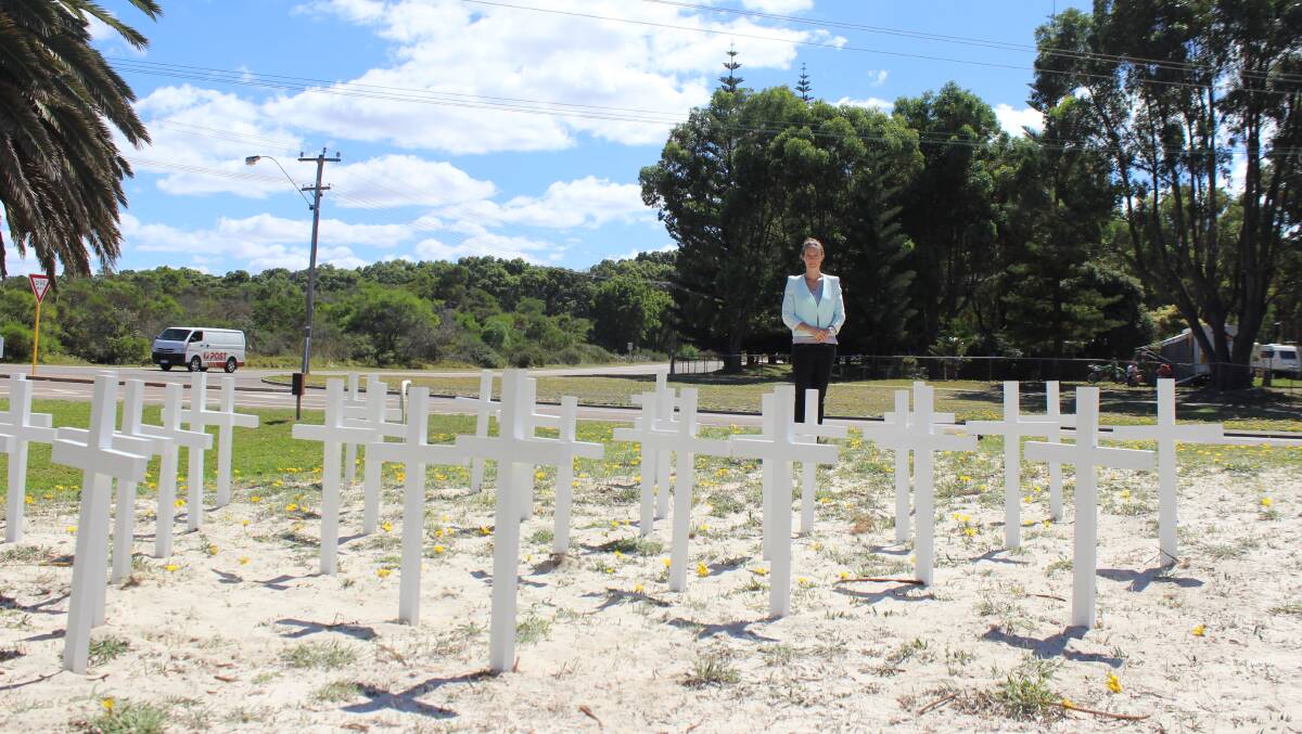 Western Australian Local Government Association Goldfields Esperance road safety advisor Tiffany Brown with the white crosses displayed on the corner of Goldfields and Norseman roads in Esperance. Each one represents a life lost on WA roads in 2015. Photo: Kristin Macfarlane/Esperance Express. 