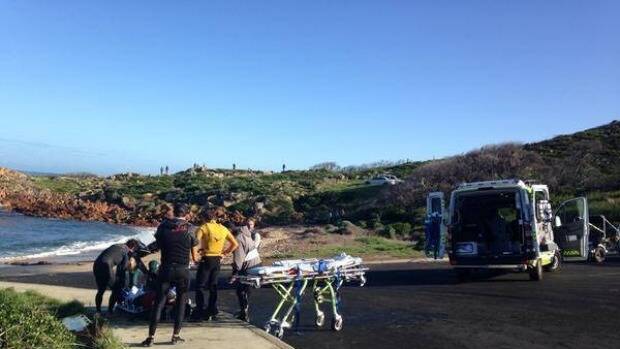 Justin Holland receives medical attention after he wiped out at famous Gracetown surf break Photo: @Roxanne_Taylor, ABC News