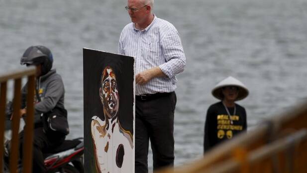 Lawyer Julian McMahon carries what will be the final self-portrait painted by Myuran Sukumaran. Photo: Reuters