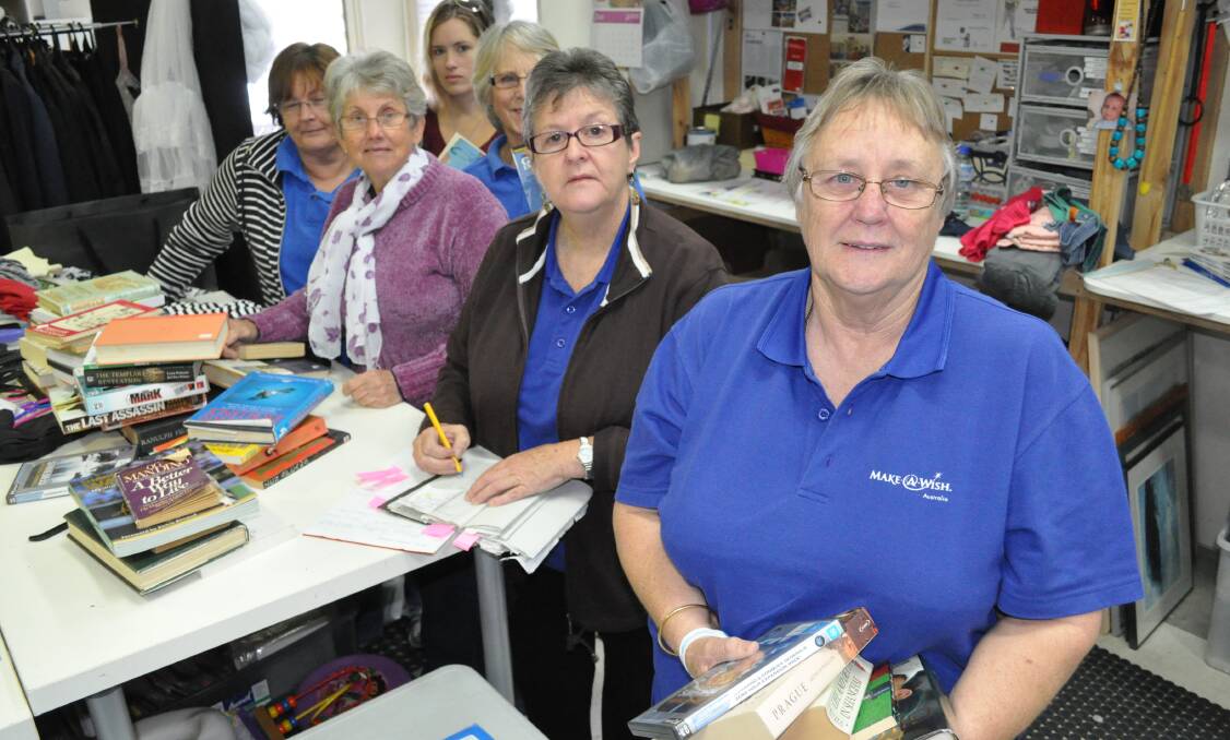 All hands on deck: Make-A-Wish Mandurah/Rockingham branch president Christine Hodge with a small army of volunteers working to get their shop back on track.