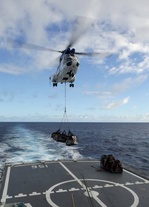 Cesar Chavez's Super Puma helicopter delivers much needed fresh food and stores to HMAS Toowoomba who have been assigned to Operation Southern Indian Ocean in search of missing Malaysia Airlines Flight MH370 on April 12. Photo: Kelli Lunt/Getty Images.