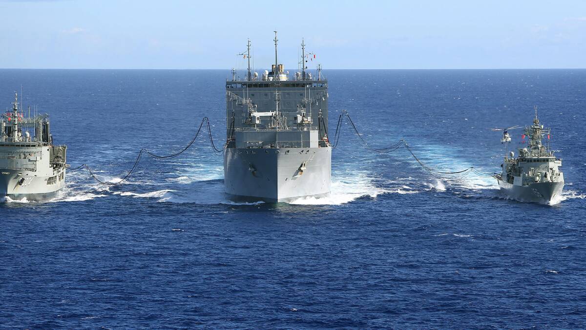 HMA Ships Success and Toowoomba conduct a Replenishment at Sea with United States Navy Ship (USNS) Cesar Chavez, whilst on Operation Southern Indian Ocean, in search of missing Malaysia Airlines Flight MH370 on April 12. Photo: James Whittle/Getty Images.