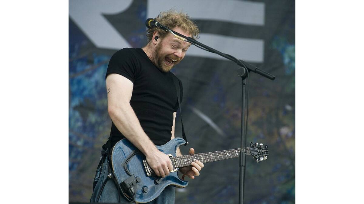 Mark Hosking performing live on stage with Karnivool at Sonisphere Festival in 2010 at Knebworth House.