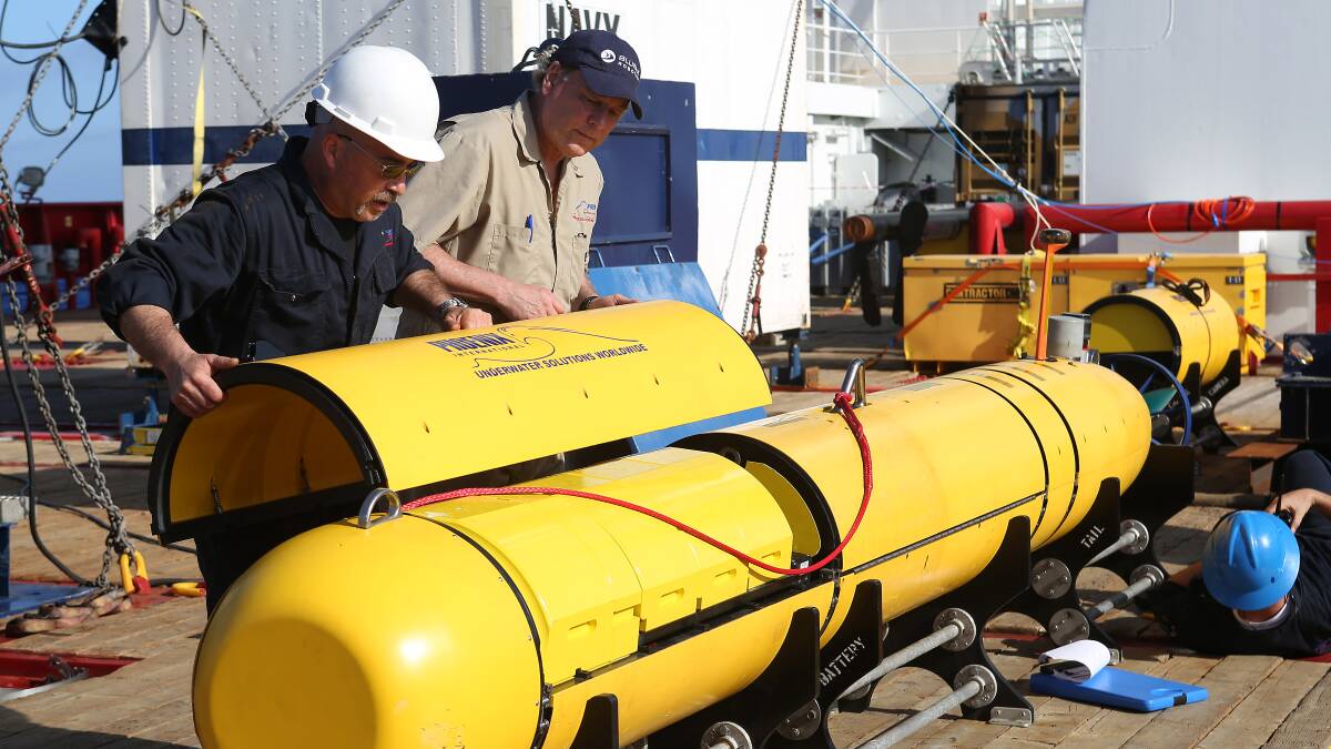 Phoenix International's Chris Minor and Curt Newport button up the Autonomous Underwater Vehicle (AUV) Bluefin-21 before it is launched off Australian Defence Vessel Ocean Shield in the search for missing Malaysia Airlines flight MH 370 on April 14. Photo: Kelli Lunt/Getty Images.