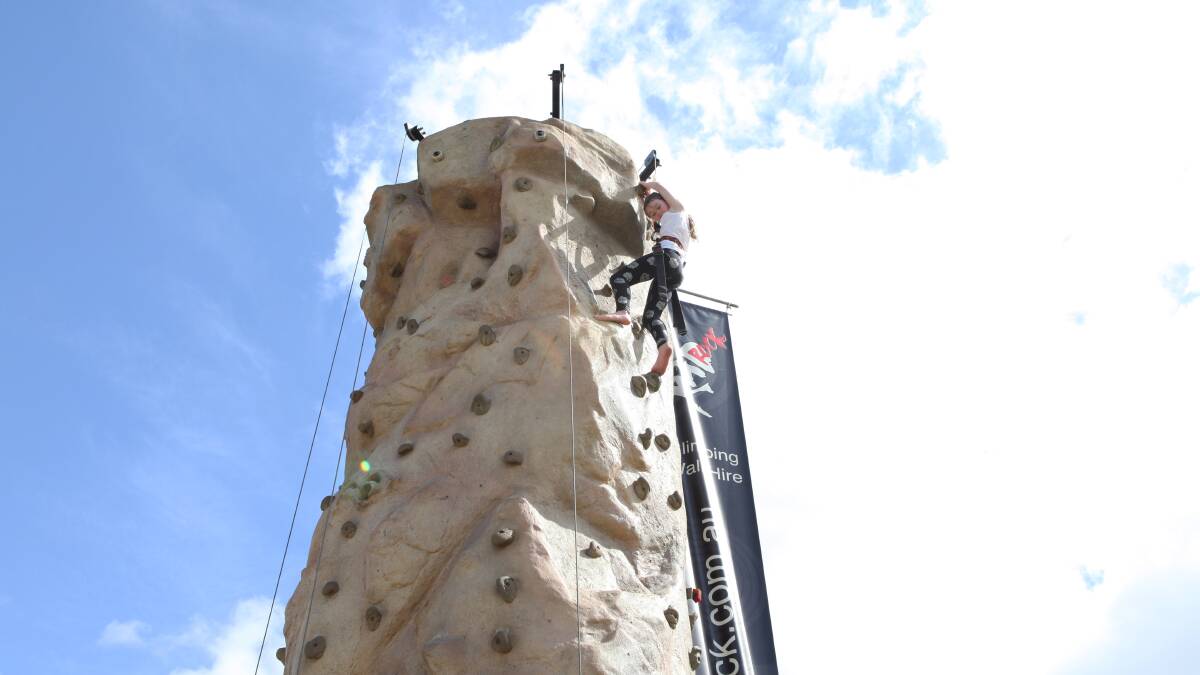 Rose Torrisi reaching the top of the rock wall.