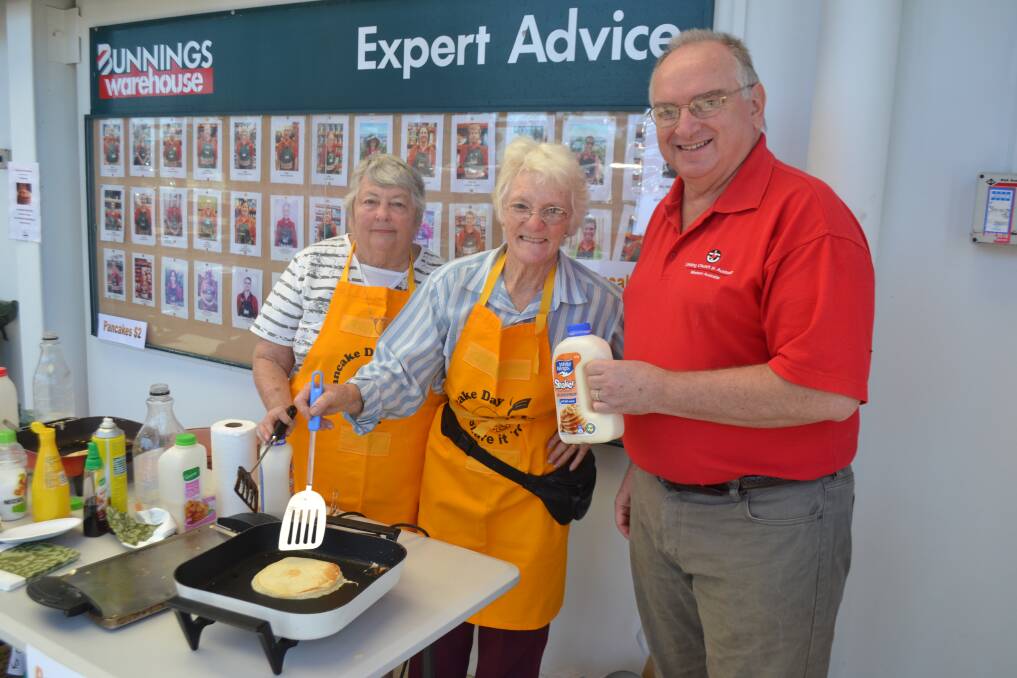 Marg Jaggs, Shirley Joiner and Reverend Ian Pearse were “battling to keep up” with orders for $2 pancakes this morning.