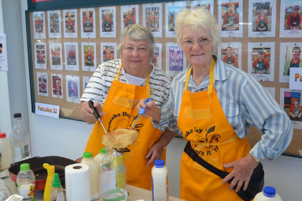 Cooking up a storm: Uniting Church volunteers Marg Jaggs and Shirley Joiner made pancakes this morning.