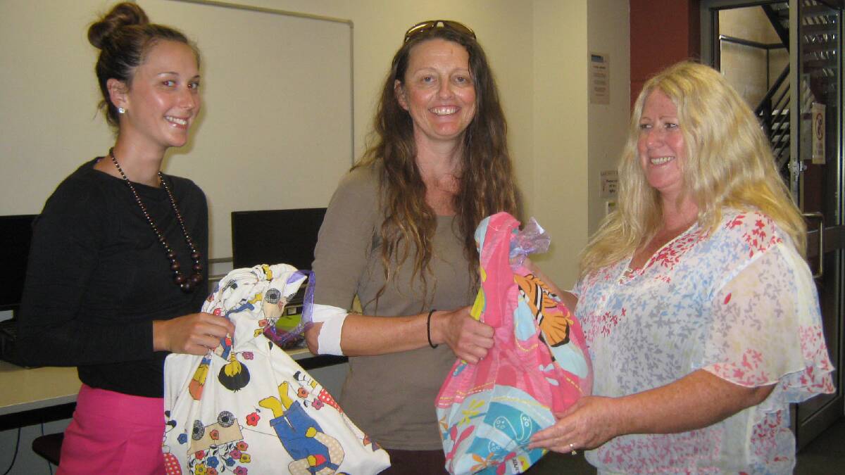 Helping hand: Amanda Wilkinson, Reach Out Drop In Centre coordinator Nikki Wise and Penelope Hewitt with the children’s gift bags. 