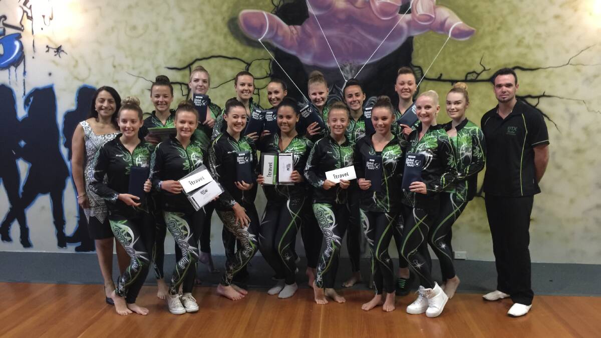 The dance team holding their plane tickets. Photo: supplied. 
