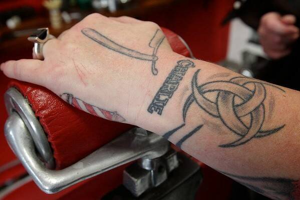 The tattooed hand of Sasha Coxon, from Chops 'N Charlies Barbers in Sydney. Photo Danielle Smith