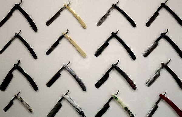 Cut throat razors decorate the wall of Chops 'N Charlies Barbers in Sydney. Photo Danielle Smith