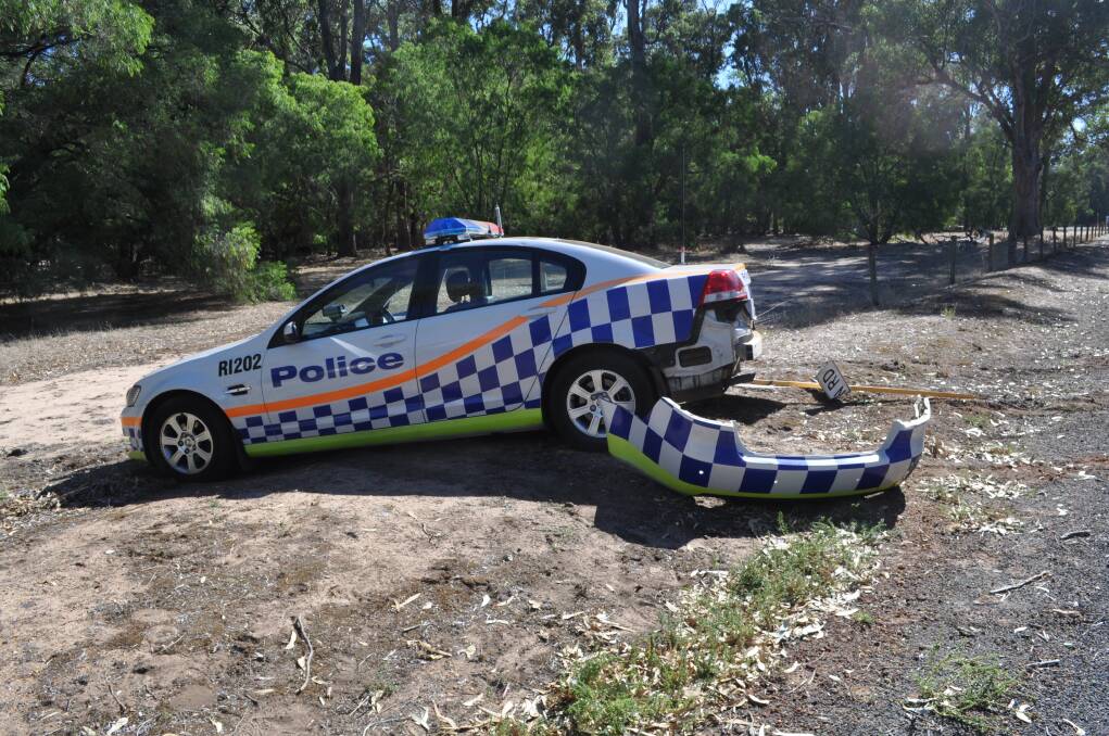 The damaged police car and stolen vehicle.