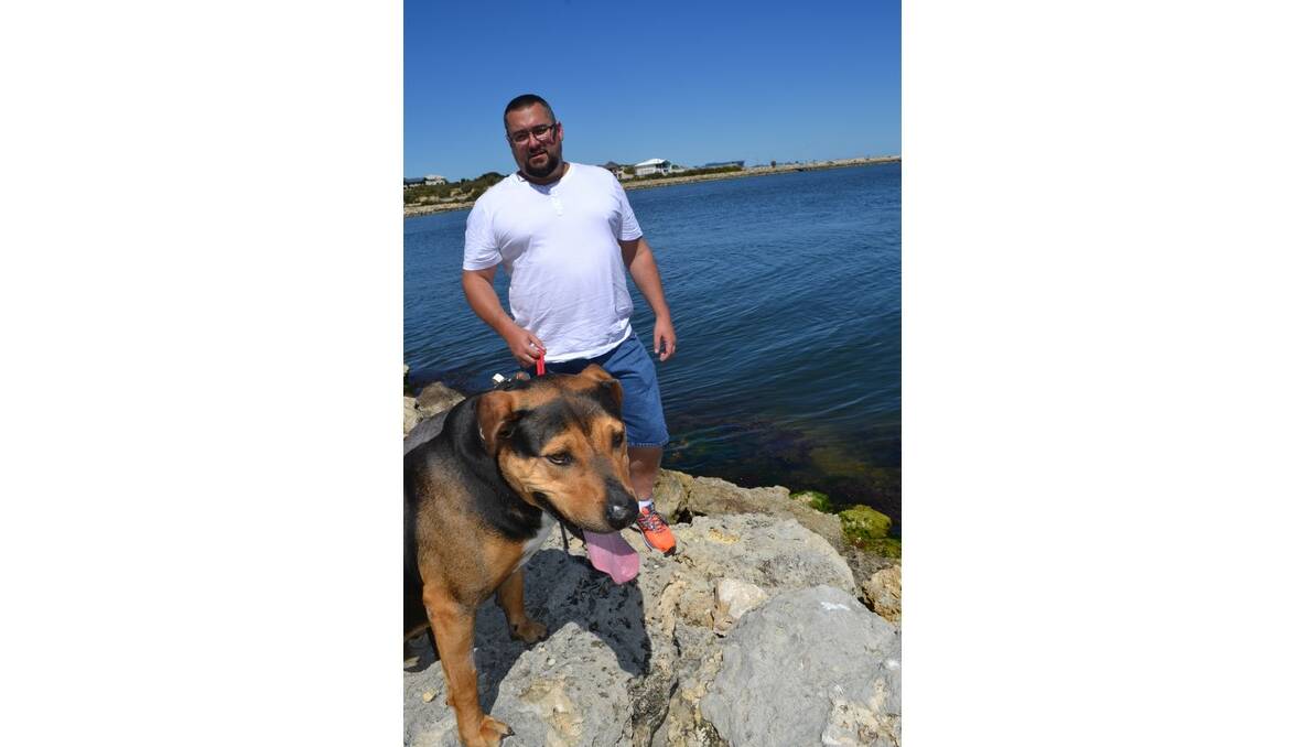 When predators attack: Wannanup dog Rhodey, pictured here with his owner Dean Carter, was bitten by a “massive” sea lion in the estuary last week.