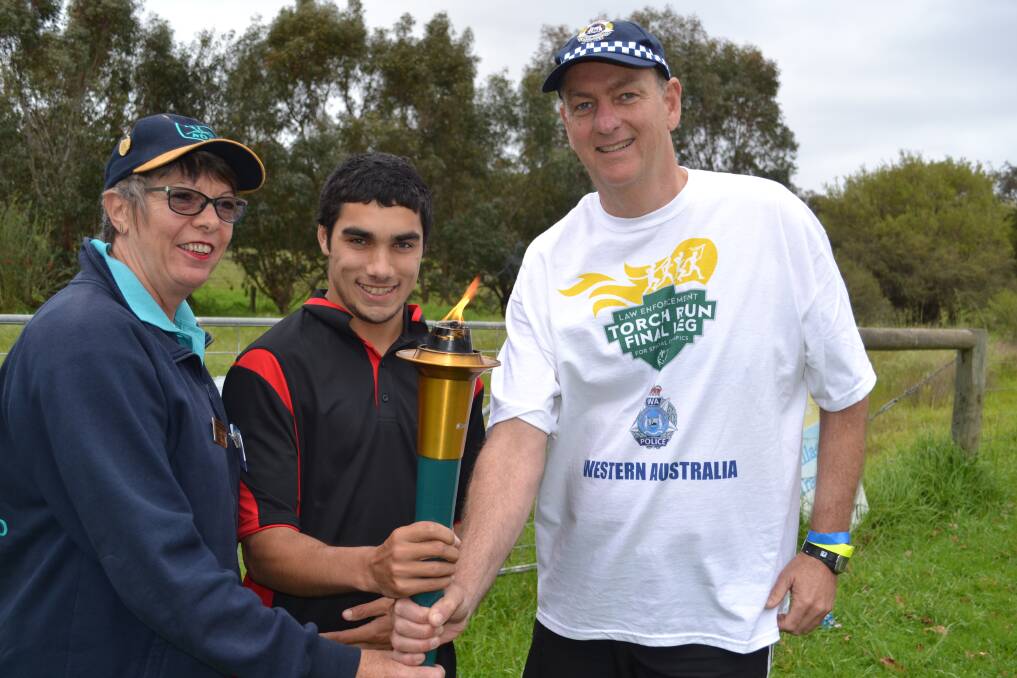 Riding Develops Ability president Paula Loser, soccer and swimming competitor Brendon Masters and Peel police super intendant Peter Halliday took part in the torch relay.