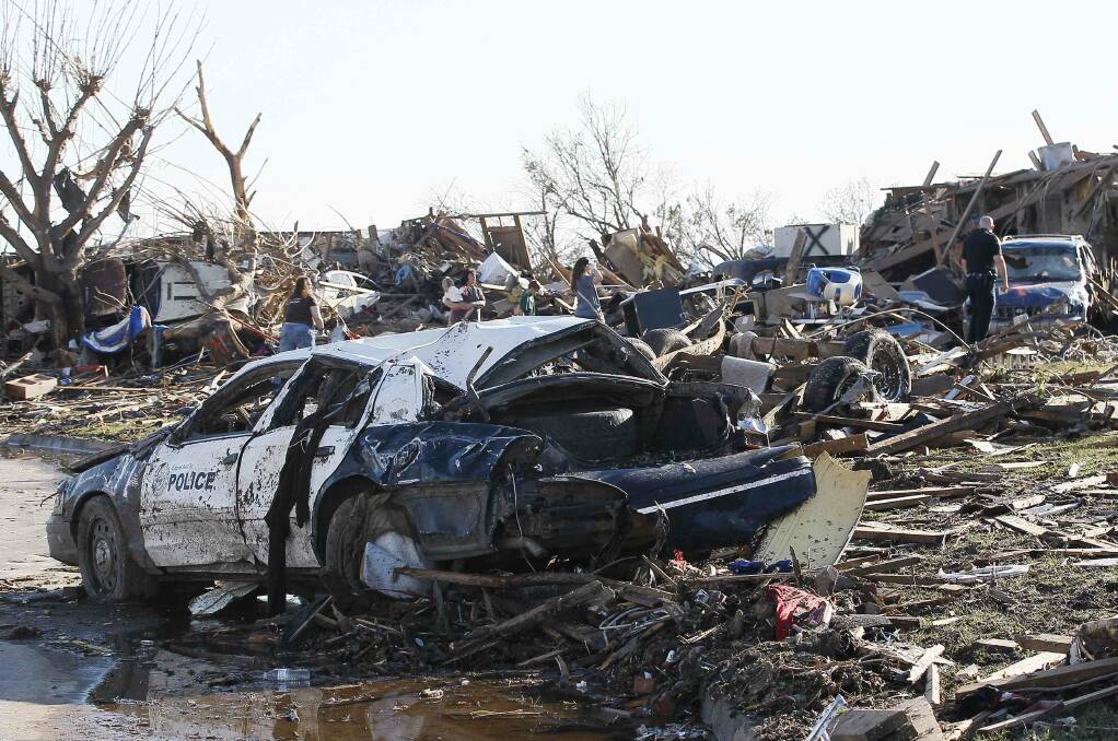 A police car destroyed by a tornado sits on the street in Moore, Oklahoma May 21, 2013. Photo: REUTERS/Rick Wilking