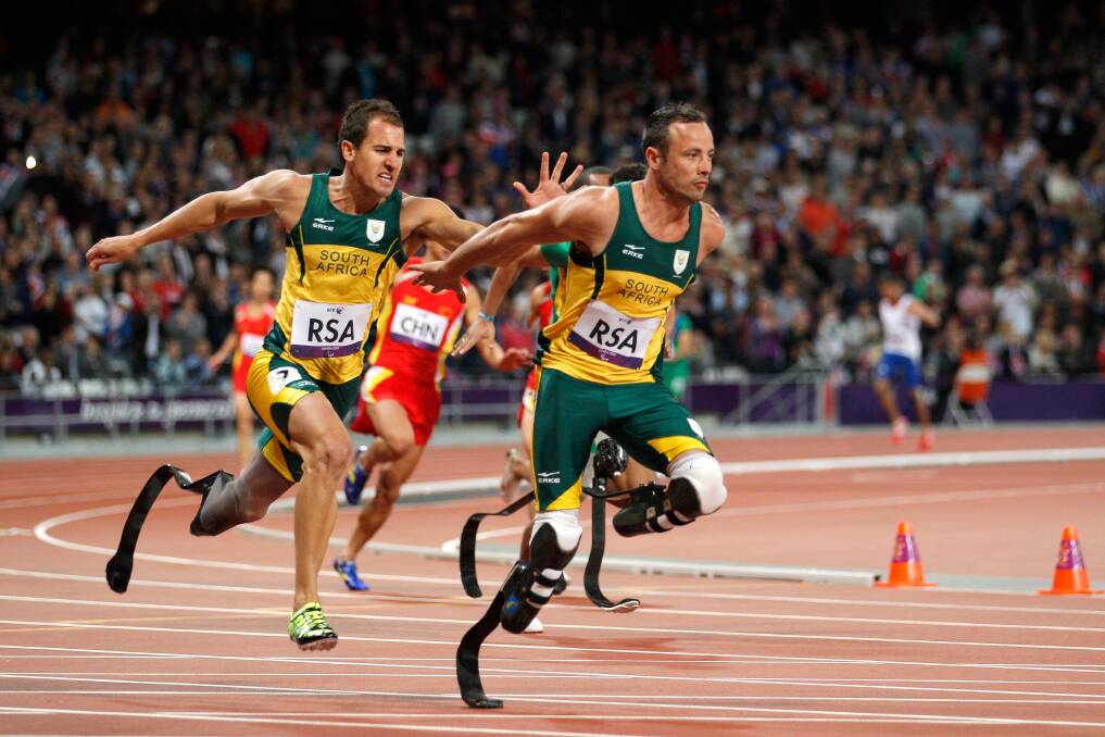 Arnu Fourie passes over to last leg Oscar Pistorius in the Men's 4x100m relay T42/T46 Final on day 7 of the London 2012 Paralympics. Photo by Harry Engels/Getty Images