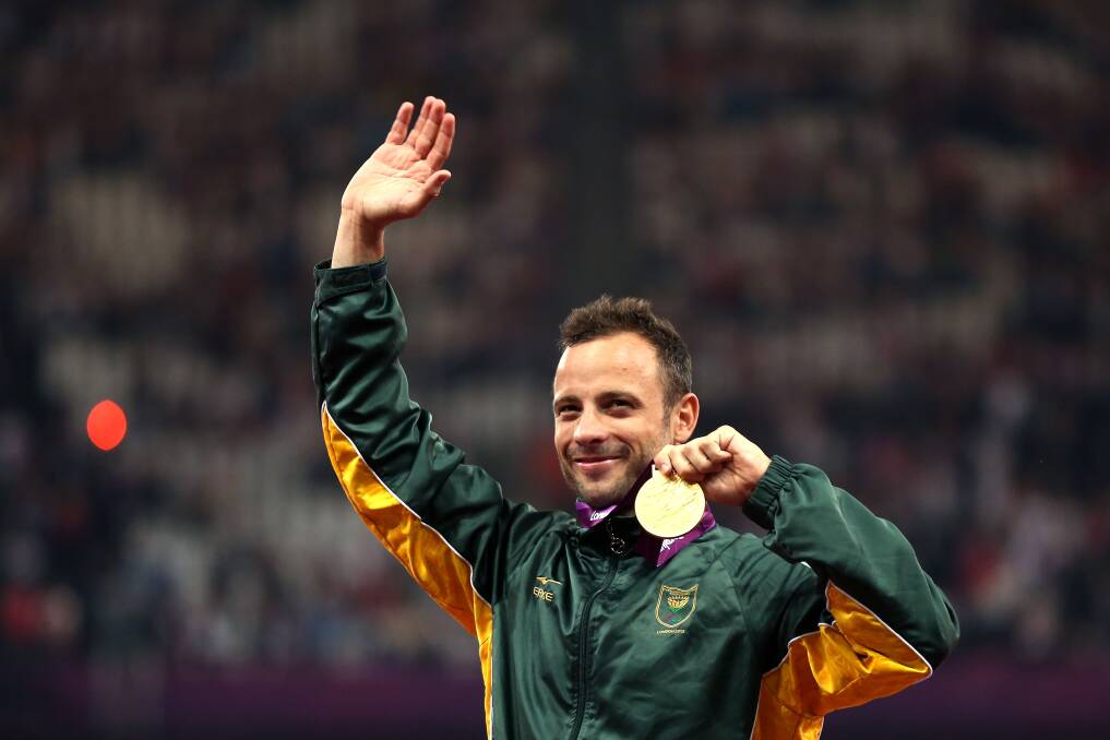 Oscar Pistorius poses on the podium during the medal ceremony for the Men's 400m T44 Final on day 10 of the London 2012 Paralympics. Photo by Bryn Lennon/Getty Images
